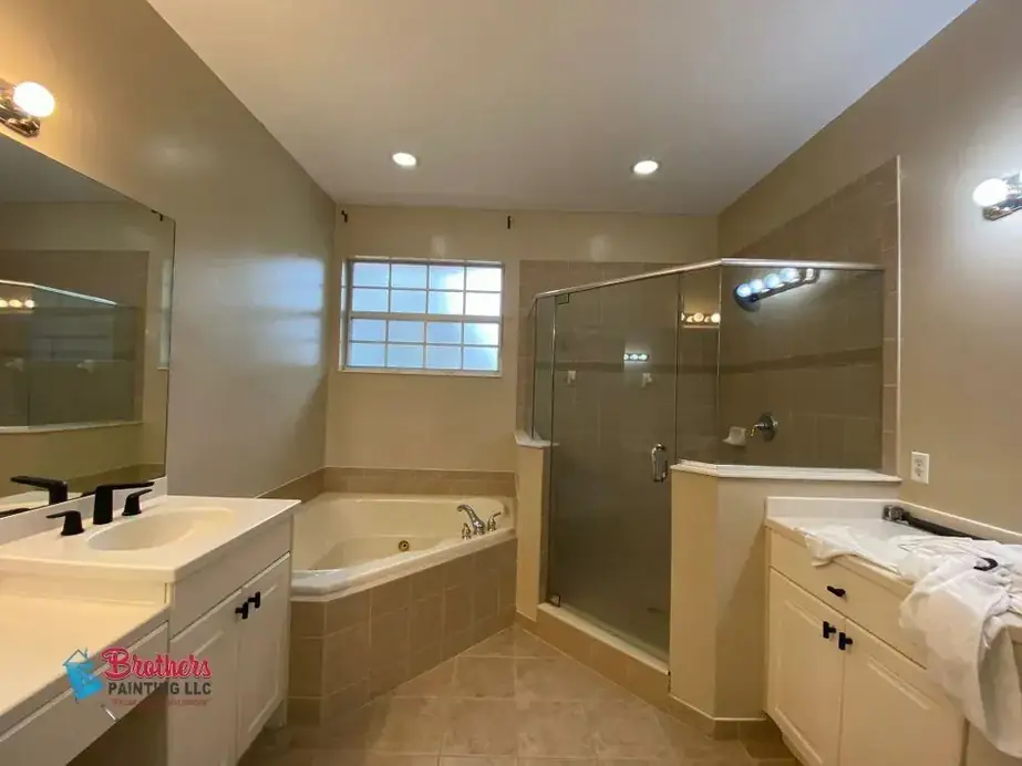 Finished bathroom with fresh beige walls, white trim and a corner tub